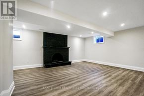 Vaughan (East Woodbridge) apartment for rent - A spacious living room with a fireplace and wood flooring.