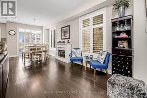 Brampton (Bram West) apartment for rent - A living room with a fireplace and a dining table.
