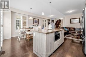 Brampton (Bram West) apartment for rent - A kitchen with a white island and wooden floors.