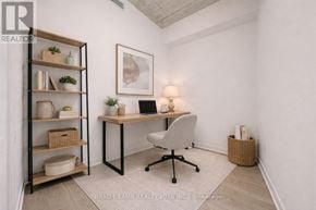 Toronto (Moss Park) condo for rent - A room with a desk, chair, and shelves with plants and baskets.