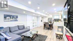 Whitchurch-Stouffville (Stouffville) apartment for rent - A living room with a grey couch and a glass table.