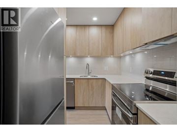 Vancouver townhouse for rent - A modern kitchen with wooden cabinets and stainless steel appliances.