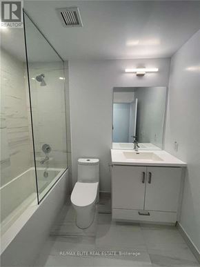 Vaughan (Concord) condo for rent - A white bathroom with a toilet, sink, and shower.