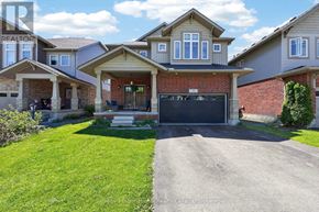 Collingwood apartment for rent - A house with a red brick wall and a black garage door is for sale.