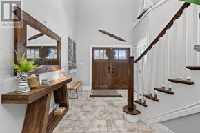 Collingwood apartment for rent - A wooden staircase with a white railing leads to a door.
