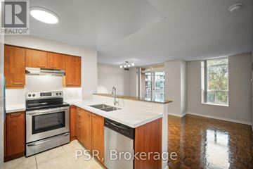 Toronto (Lawrence Park South) condo for rent - A kitchen with wooden cabinets and a stainless steel oven.