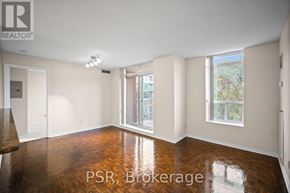 Toronto (Lawrence Park South) condo for rent - A room with wooden floors and white walls, with a window showing a view of trees and a fence.
