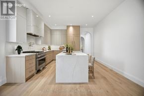 Mississauga (Port Credit) apartment for rent - A modern kitchen with a center island and wooden floors.