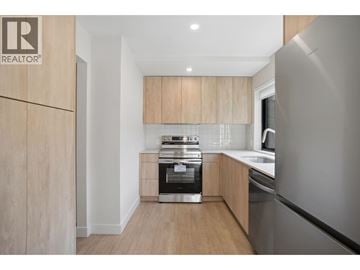 Vancouver townhouse for rent - A modern kitchen with wooden cabinets and stainless steel appliances.