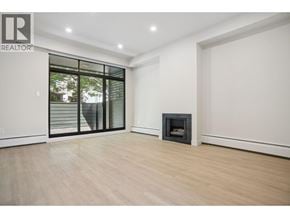 Vancouver townhouse for rent - A modern kitchen with a stainless steel refrigerator and wooden flooring.