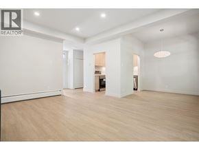 Vancouver townhouse for rent - A spacious room with wooden flooring and white walls.
