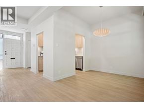 Vancouver townhouse for rent - A large, empty room with wooden floors and white walls.