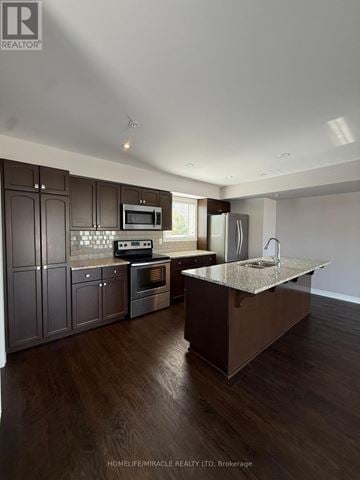 St. Catharines (Secord Woods) townhouse for rent - A modern kitchen with dark wood cabinets and a central island.