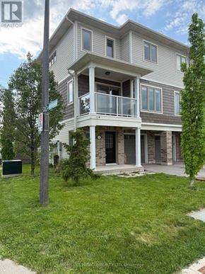 St. Catharines (Secord Woods) townhouse for rent - A two story house with a balcony on the second floor.