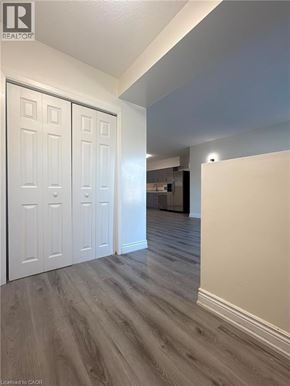 Niagara Falls apartment for rent - A hallway with white doors and wood flooring.
