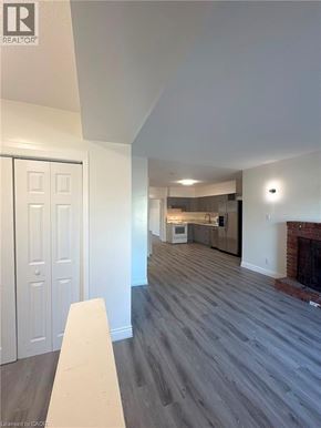Niagara Falls apartment for rent - A realtor photo of a room with wood floors and a fireplace.