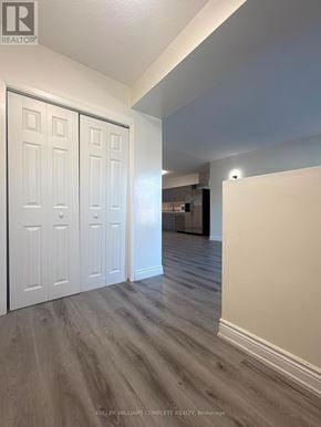 Niagara Falls (Cherrywood) multi-family for rent - A room with a white door and a wooden floor.