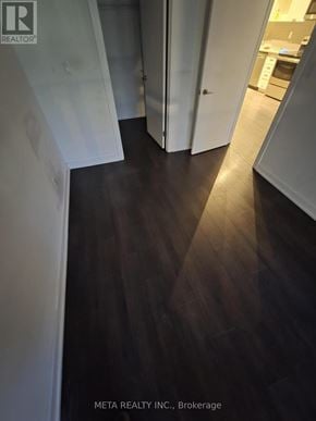 Toronto (Niagara) condo for rent - A hallway with a wooden floor and white walls.