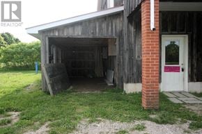 Shelburne apartment for rent - A garage with a white door and a brick pillar.