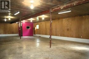 Shelburne apartment for rent - A large empty room with a red wall and a wooden floor.