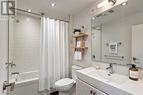 Toronto (Palmerston-Little Italy) multi-family for rent - A bathroom with a white toilet, sink, and shower.
