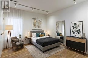 Toronto (Palmerston-Little Italy) multi-family for rent - A bedroom with a large bed, a chair, and a painting on the wall.