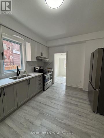 Toronto (Palmerston-Little Italy) apartment for rent - A kitchen with a refrigerator on the right side.