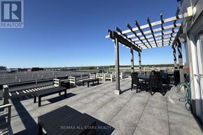Markham (Cornell) condo for rent - A rooftop patio with a pergola and seating area.