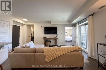Markham (Cornell) condo for rent - A bedroom with a bed covered in a yellow blanket.