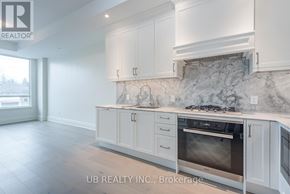 Ottawa condo for rent - A kitchen with white cabinets and a marble backsplash.