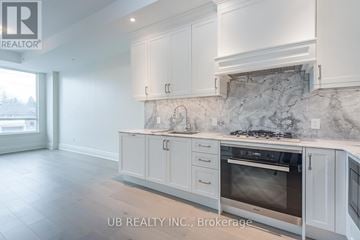 Ottawa condo for rent - A kitchen with white cabinets and a marble backsplash.
