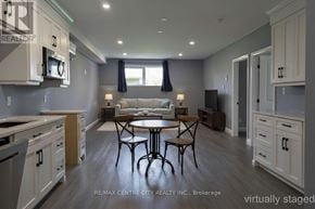 Aylmer apartment for rent - A kitchen with a table and chairs in the middle.