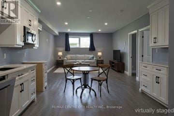 Aylmer apartment for rent - A kitchen with a table and chairs in the middle.