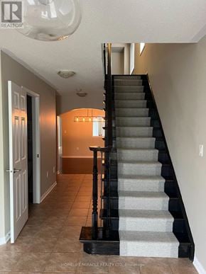 Milton (Co Coates) apartment for rent - A staircase with a black handrail and grey steps.