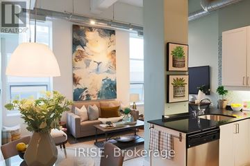Toronto (Church-Yonge Corridor) condo for rent - A modern kitchen with a dining table and chairs, a sofa, and a large abstract painting on the wall.