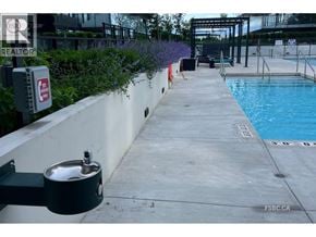 Richmond apartment for rent - A pool area with a diving board and a pool ladder.
