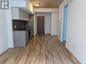 Toronto (South Riverdale) condo for rent - A kitchen area with wooden floors and a countertop.