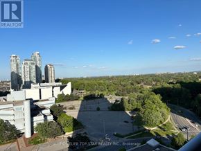 Toronto (Bendale) condo for rent - A view of a cityscape with tall buildings and a parking lot in the foreground.