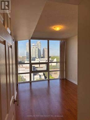 Toronto (Bendale) condo for rent - A room with a view of the city skyline through large windows.