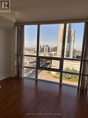 Toronto (Bendale) condo for rent - A room with a view of the city skyline through large windows.