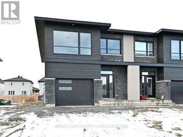Alfred And Plantagenet apartment for rent - A modern house with a grey exterior and a black garage door.