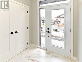 Alfred And Plantagenet apartment for rent - A white door with a glass window is open to a snowy street.