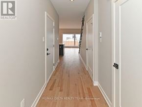 Alfred And Plantagenet apartment for rent - A hallway with wooden floors and white walls.