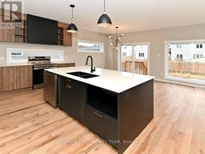 Alfred And Plantagenet apartment for rent - A modern kitchen with a large island and wooden floors.