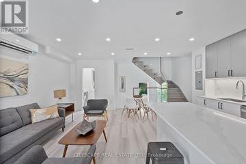Toronto (Oakwood Village) condo for rent - A modern living room with a grey sofa and wooden coffee table.