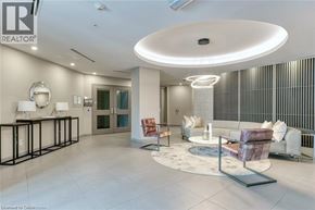 Burlington condo for rent - A well-lit, modern living room with a circular light fixture and a sofa.