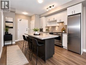 Burlington condo for rent - A modern kitchen with a center island and stainless steel appliances.