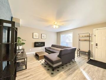Surrey apartment for rent - A living room with a grey couch and a wooden coffee table.