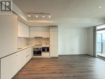 Vaughan (Vaughan Corporate Centre) condo for rent - A kitchen with white cabinets and a marble backsplash.