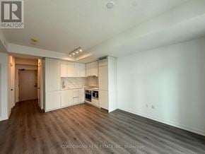 Vaughan (Vaughan Corporate Centre) condo for rent - A spacious room with a kitchenette and wooden flooring.